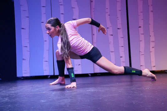 a dancer performing on stage wearing sets of HVY Sleeves on their arms and legs