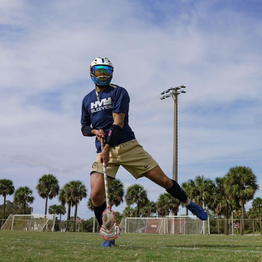 a lacrosse player practicing with HVY Sleeves on their arms and legs