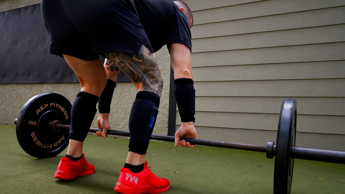 a man preparing to deadlift while wearing weighted leg and ankle weights